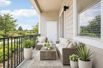 Private balcony with cushioned seating and planters